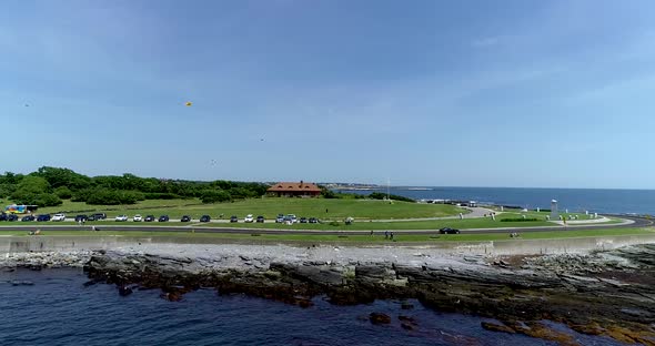 Brenton Point in Newport Rhode Island.  Features drone shot of shoreline with cars and kites. alt