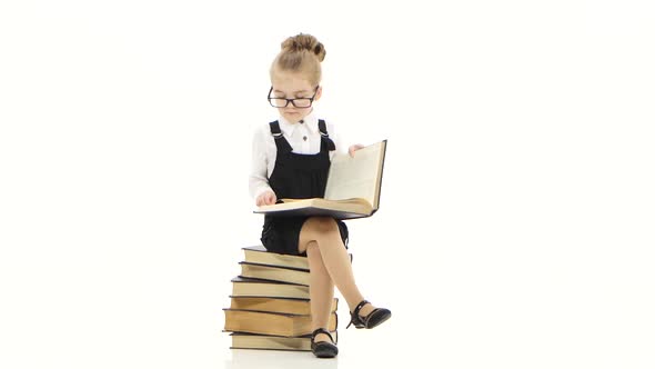 Clever Little Girl Is Reading Big Book on White Background alt