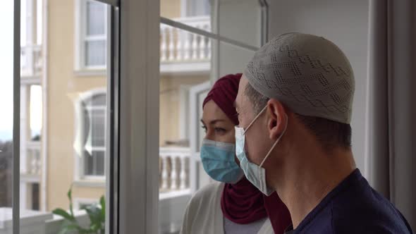 Lockdown Ramadan. Sad Arabic Muslim family couple man and woman in mask alt