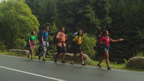 Positive Diverse Multicultural Backpackers Enjoying Scenic Mountain Nature During Trek alt