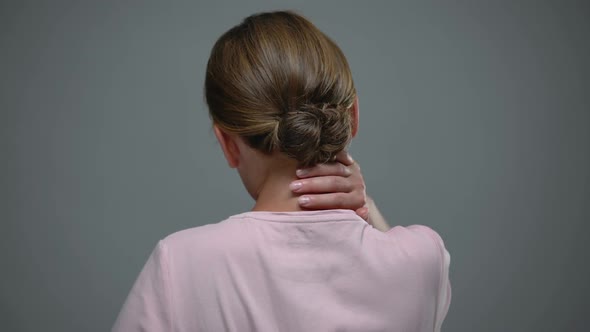 Woman Massaging Neck, Pinched Nerve, Result of Sedentary Lifestyle, Back View