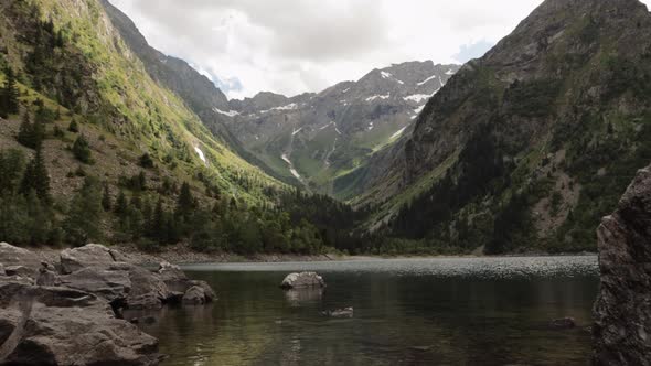 Gimbal dolly shot stepping into the beautiful Lauvitel lake in Venosc, Alps. 4K ProRes alt