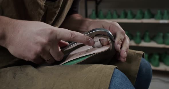 Close Up View of Tailor Nailing and Fixing Blank for Shoes in Private Leather Craftshop with Pliers