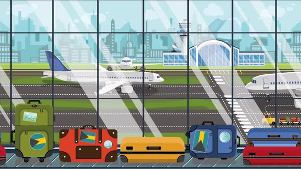 Suitcases with Bahamian Flag Stickers on Baggage Carousel alt