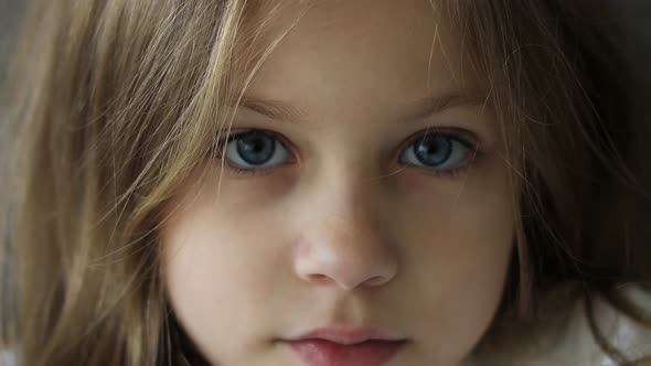 Close Up Portrait of a Beautiful Nineyearold Girl with Blue Eyes