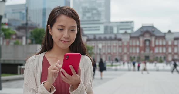 Woman use of smart phone in Tokyo station alt