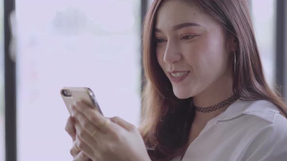 happy woman using smartphone to social network alt