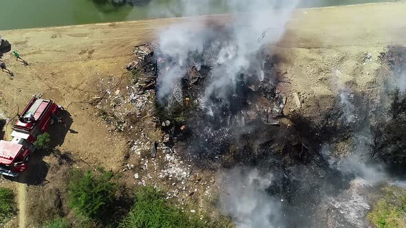 Aerial view of a structure fire,  smoke rising from a building in flames cloudy day, Arson in Mexico alt