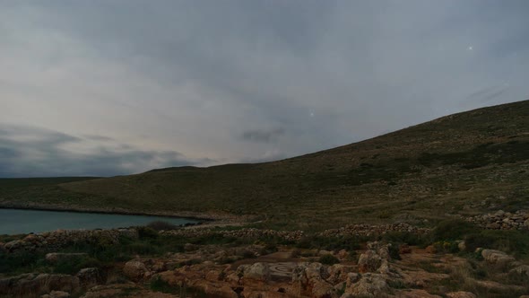 Time Lapse moving clouds on night sky at ruin of roman baths on second southest point of Europe, Lig alt