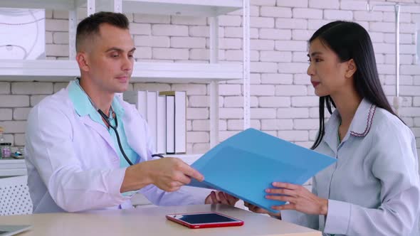 Doctor in Professional Uniform Examining Patient at Hospital alt