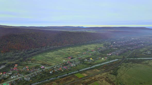 Aerial Top Dow View Over Suburb Area Village Near Mountain High Altitude View Over Countryside of alt
