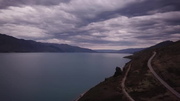 Scenic road by lake Hawea in New Zealand alt
