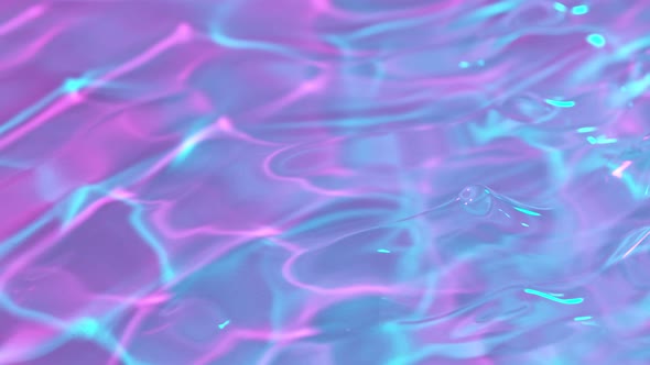 Super Slow Motion Abstract Shot of Rippling Neon Water Surface at 1000Fps. alt