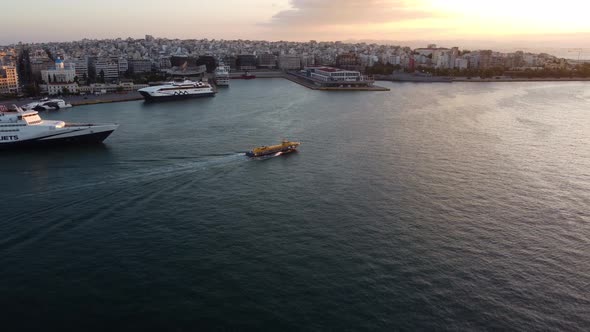 Drone View of a Lone Boat Sailing Out of the Port of Athens