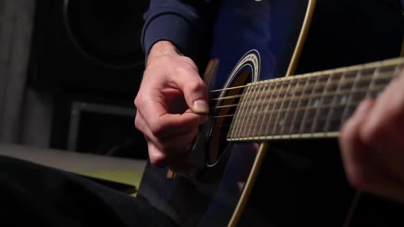 Man Plays a Pick on a Modern Guitar in the Dark Slow Mo alt