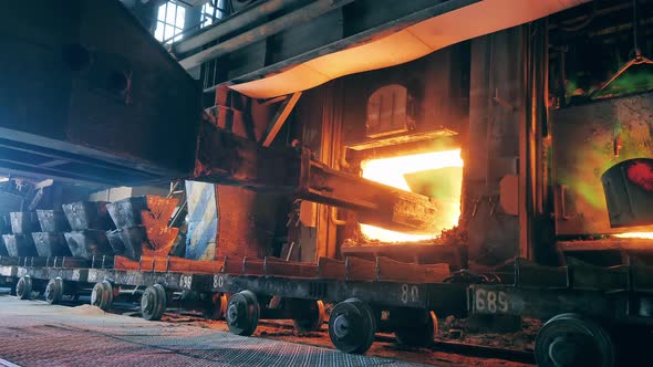 Industrial Machine is Loading Copper Materials Into a Furnace alt