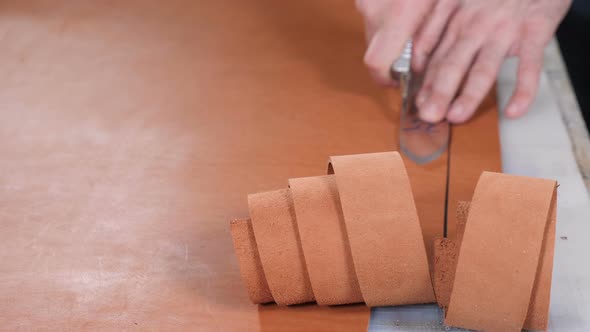 Manually Cutting Leather During Craft Manufacturing Goods alt