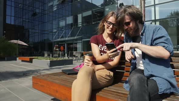 Colleagues Look Over Photos alt