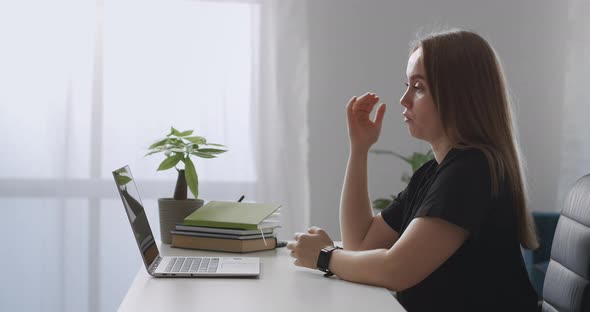 Female Coach Is Consulting Online Speaking To Webcam of Laptop Explaining and Gesticulating Webinar alt