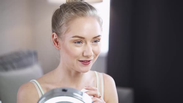 Portrait of Female Beauty Blogger Woman Shows How to Face Massage with Cotton Pads Makes a Stream on alt