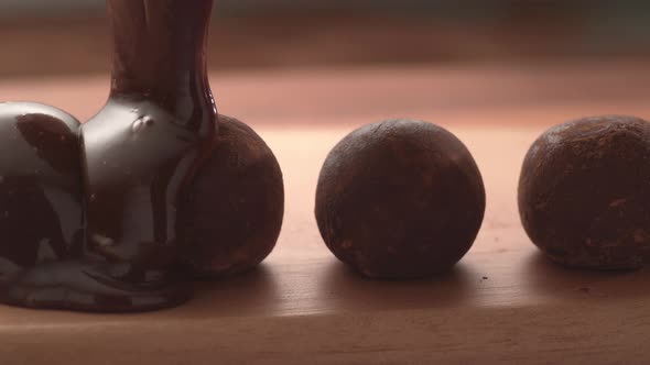 Chocolate pouring onto truffles in super slow motion.  Shot on Phantom Flex 4K high speed camera.