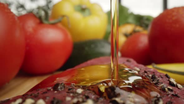 Zoom out macro video of olive oil on raw steak. Shot with RED helium camera in 8K alt
