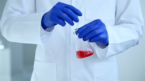 Scientist Dropping Liquid Substance