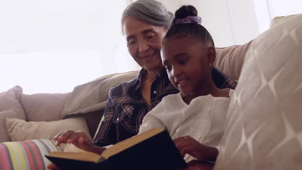 Mature woman enjoying time with her granddaughter alt