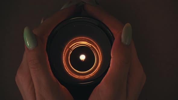 Candle Burns Atmospherically in the Hands of a Girl with a Beautiful Manicure alt