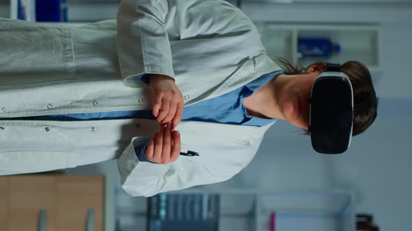 Vertical Video Neurological Scientist Using Medical Inovation in Lab Wearing VR Glasses alt