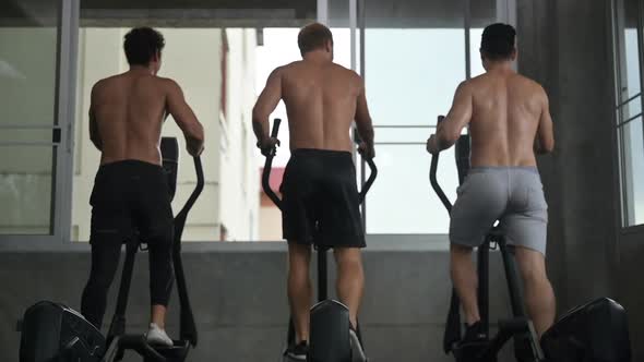 athlete people exercise and training at sport gym, fitness workout with bicycle equipment alt