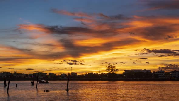 Dramatic sunset on river with colorful cloud and sky