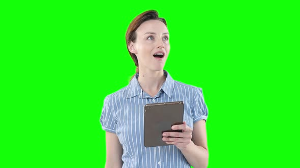 Caucasian woman using a digital tablet on green background alt