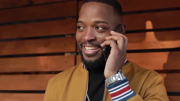 African-American Man Chatting in Smartphone, Outdoors