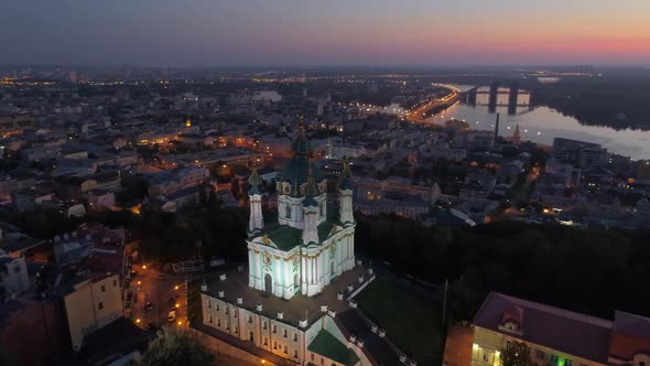 St. Andrew's Church with Illumination in Kiev (Kyiv), Ukraine. Aerial Shot Early in the Morning alt