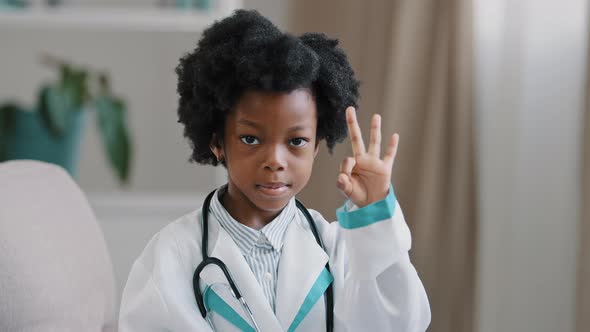 Closeup African American Little Girl Standing in Medical Clothes Playing Pretending to Be Doctor alt