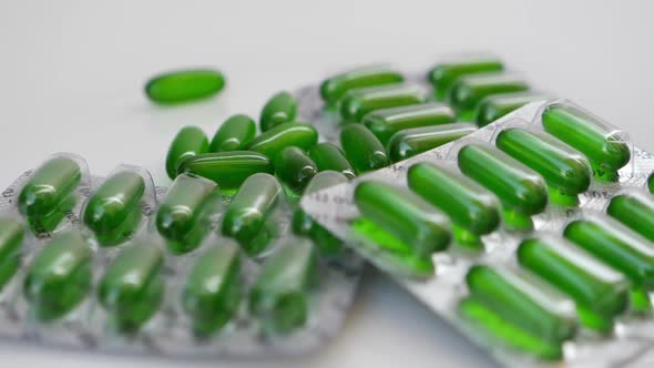 Rotating view of green capsule packets