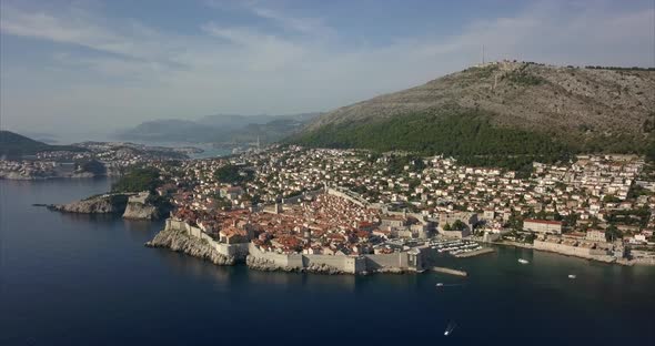 Aerial footage of Dubrovnik old town. Wide shot showing all of the ancient city, slowly pushing in t alt