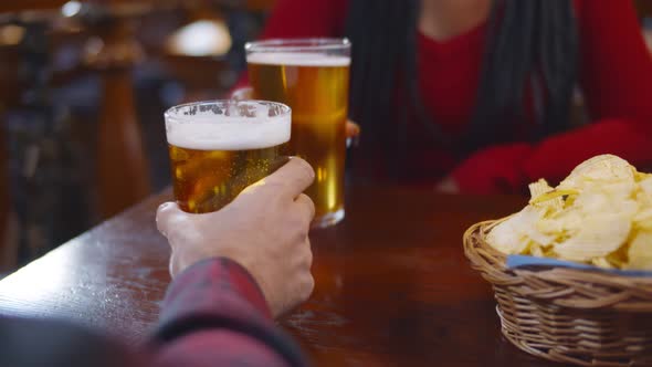 Close Up of Waiter in Safety Gloves Serving Glasses of Beer To Customers in Pub alt