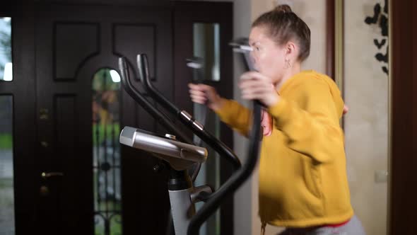 girl loses strength during training and slides down the sport training machine alt