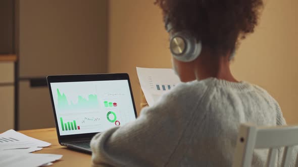 African Girl is Learning to Work with Financial Statistics on a Remote Work at Home Working with alt