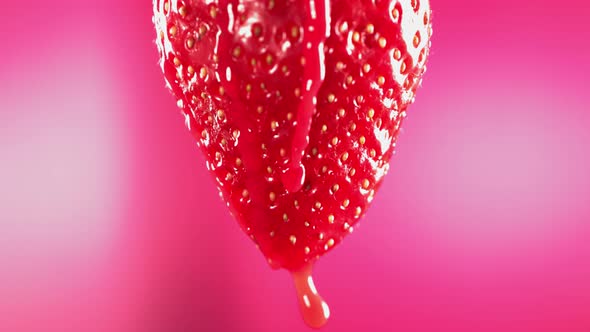 Slow Motion Macro Shot of Flowing Juice From Strawberry alt
