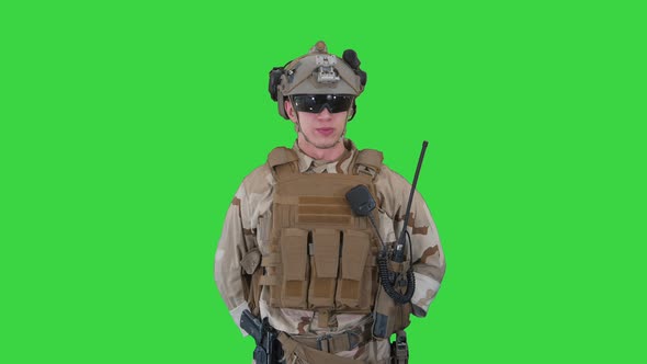 US Military Soldier in Uniform Reports on a Green Screen, Chroma Key. alt