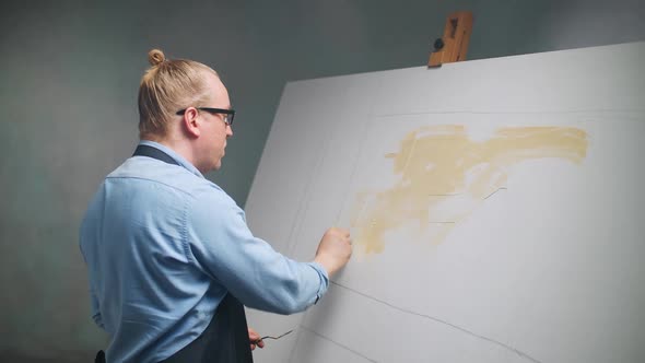 Slow Motion Creative Person at Work a Talented Adult Man Artist Covers the Canvas with Beige Oil alt