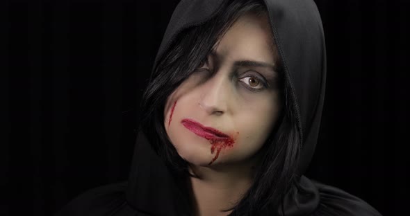 Vampire Halloween Makeup. Woman Portrait with Blood on Her Face. alt