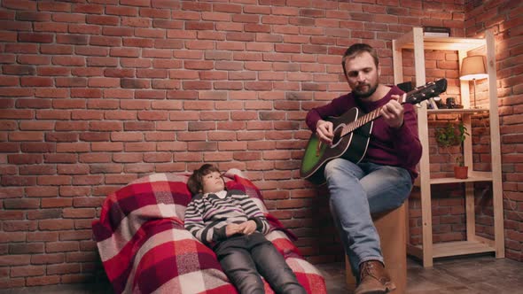 Father Playing Guitar with His Son