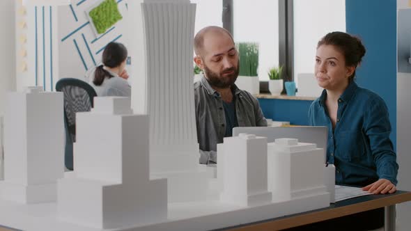 Team of Architects Designing Building Model on Laptop in Architectural Office alt