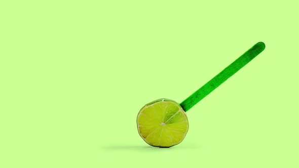 Sliced Lemon Fruit Popsicle Rotating, Green Background