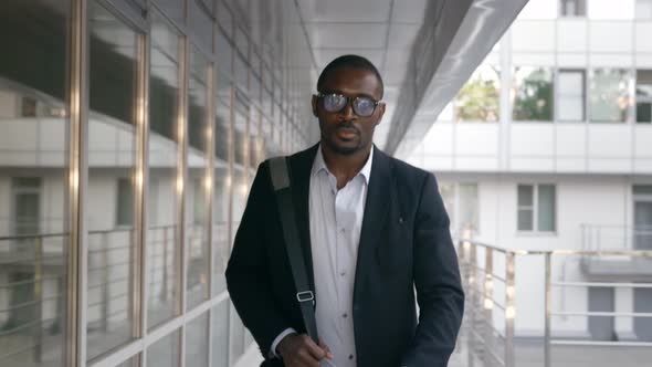 Afroamerican Young Businessman Walking to Work in City Near Office Building alt