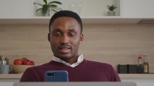 Happy Smiling African American Man Greeting His Friends on a Video Call on a Laptop at Home alt